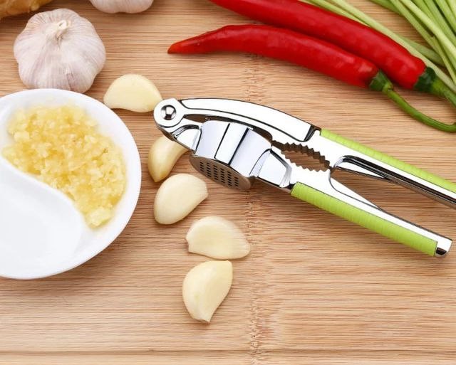 Garlic presser with walnut cracker